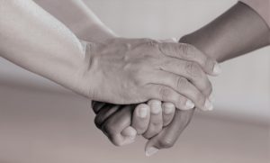 two people's hands clasped