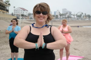 Jill Jendrzey, PeerFest planning committee member, participating in beach yoga. 