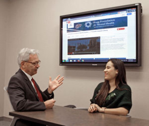 Mark Lusk, Ed.D., left, talks with a pre-nursing student about online training modules 