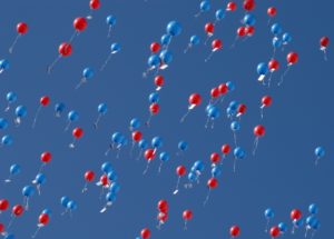 red and blue balloons floating up to the heavens