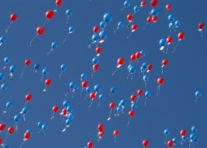 red and blue balloons floating up to the heavens