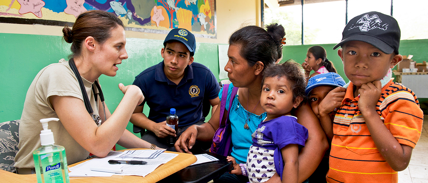 Photo of woman discussing health care with a family