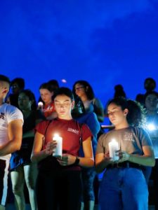People holding candles after mass shooting