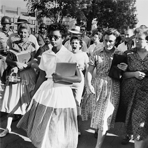 Elizabeth Eckford ignores the hostile screams and stares of fellow students on her first day of school. She was one of the nine Black students whose integration into Little Rock’s Central High School was ordered by a Federal Court following legal action by NAACP.