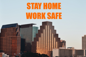A photo of a skyline with the words "stay home, work safe" on it