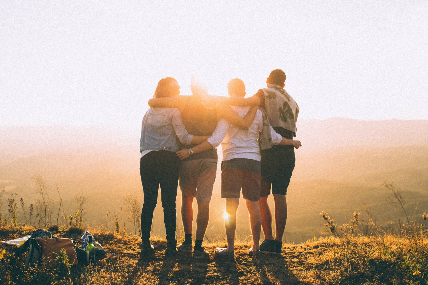 young people facing a sunset