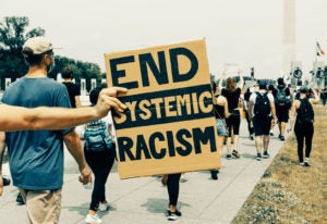 A sign that says end systemic racism