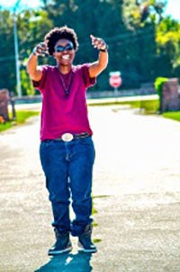 Keneisha Johnson in a dark red shirt, smiling