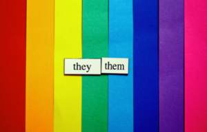 Rainbow superimposed with the word they/them.