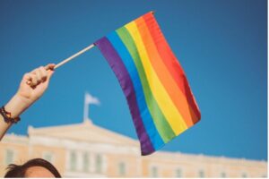 Person waving pride flag in the air