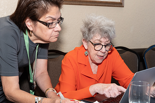 partnership-web Two older women using a laptop.