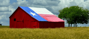 A barn painted to resemble the Texas state flag. Rural border wellness.