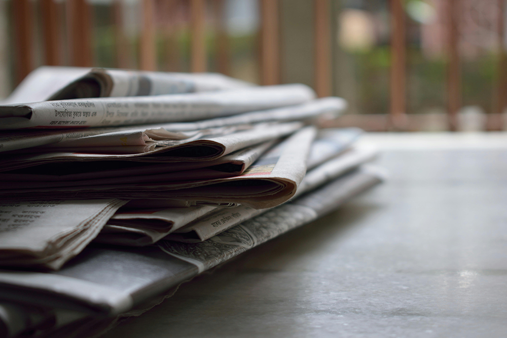 stack of newspapers on a table